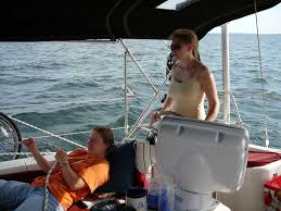 While Vickie Eiden (co-author) takes the helm, Mary Giblin trims the spinnaker on the way to Drummond Island. Photo by Tim Nolan. - Brian-Bartel-Photo-Trimming