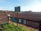 Take Note. Notices in Caldy Anglers car park, over looking ploughed field - via Daymix
