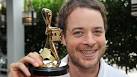Hamish Blake holding a Logie