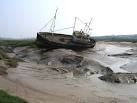 On the edge of the River Dee Pathfinder is aground in a sea of mud, - via Daymix