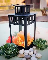 Moroccan Lanterns...what next? :  wedding centerpieces lanterns white Images?q=tbn:ANd9GcQFc I8 40Lq SAKYofXXu8aFBzF33KAuUrkJGcgxS9mjt QdYe