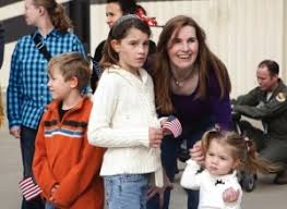 Richard Hoyt III, from left, Mara Hoyt, Michelle Hoyt and Miranda Hoyt look toward the hangars Tuesday at SJAFB. They were waiting on Richard Hoyt II to ... - Troops_Return23