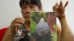 Maria Rios Cueto, holds up a photo of her nephew, Ezequiel Cordoba Rios in Tuxtla Gutierrez, Mexico, Thursday Feb. 6, 2014. (AP / Moyses Zuniga) - image