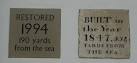 Documentary Evidence. These signs sit side-by-side on a building wall at the - via Daymix