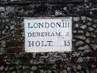 Mileage sign on wall, - via Daymix