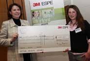 Laura Cove (right) receives her prize from Mary Anstice, General Sales and Marketing Manager for 3M ESPE - image