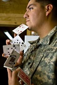 BAGHDAD -Spc. Jose Barrientos, from San Diego, shuffles a deck of cards at Joint Security Station Istaqlal, here, Oct. 21. Barrientos is an illusionist who ... - size0-army.mil-53956-2009-10-23-111003