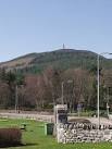 The conifer-clad hill is - via Daymix