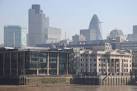 The tall buildings of the city of London viewed from the Millennium Bridge, - via Daymix