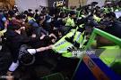 South Korean protestors clash with riot police during a rally to.