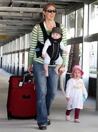 Carina de Vries with her daughter Ava, 2, and son Zachary, 6 months, after walking to the pickup area. Photographer: Liam Kidston. Picture: Liam Kidston - 489745-airport-pickup-5