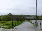 The small hump in the road half way to the house is the bridge over the - via Daymix