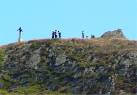 Girl on the Trig. Group of young climbers having fun at the summit of - via Daymix