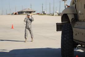 FORT HOOD, Texas- Pfc. Jenny Cueva, with 3rd Brigade Combat Team, 1st Cavalry Division, ground guides a mine resistant ambush protected vehicle 5 as ... - size0-army.mil-88919-2010-10-18-131012