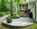 Wooden and stone garden bench on stone patio with leaf design in ...