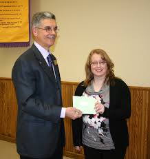Hannah Rodger received the 2011 Optimist Youth Scholarship from past club president Peter Lade on Jan. 25 to recognize her more than 850 volunteer hours. - new-dundee-optimist-scholarshipweb