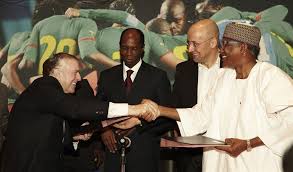 Horst Widmann of PUMA shakes hands with the Mohammed Iya ...