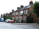 Note the assortment of satellite TV dishes and wheely bins. - via Daymix