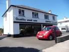 Used car showroom on Milton Street with a red Nissan outside. - via Daymix