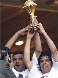 Khaled Badra and Riadh Bouazizi lift the trophy. The suspended Khaled Badra and Riadh Bouazizi lift the trophy - _39860661_bouazizi_badra270