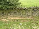 Soil erosion under wall at Upper Cote, Fixby - via Daymix