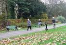 A photography student attempts to get passers by to sit on a park bench as a - via Daymix