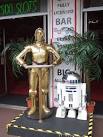 The Star Wars droids by the pavement at Golden Palms Amusements on Cary - via Daymix