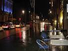 Looking along High Street on a wet evening as traffic speeds across the - via Daymix