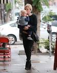 Make-up free Malin Akerman dotes on son Sebastian as she braves.