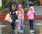 Denise Richards braves the rain for shopping trip with daughters.