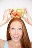Woman with fruit bowl on head. By: MGP. Photolibrary - 139834999