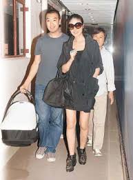 Kelly Chen (M) and Alex Lau walk out of a hospital in Hong Kong on Wendesday, July 15, 2009. - 00114320c9df0bce128c10