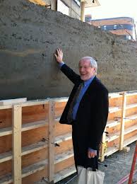 Jim Stockard inspecting the wall - mud-hall-5-023