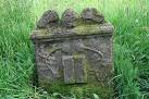 This symbolic headstone has carved flowers which is a symbol of immortality - via Daymix