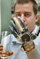 Handy: Christian Kandlbauer shows off the mind-controlled arms he drives ...