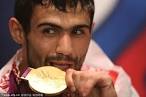 Judo wrestler Arsen Galstyan bites his gold medal in the Russia Park ... - 000802aa2f49117fbdfe5a