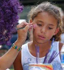 070308 – Aaliyah Wright, 9, gets her face painted by Nancy “Lu-Lu the Clown” Linder at the Burlington fourth of July celebration at City Park. photo daniel ... - 070308-news-Aaliyah-Weaver