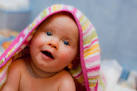 Baby in bath towel by Karsten Brand