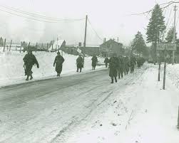 U.S. Army reinforcements enter Bastogne on Dec. 27, 1944, after WWII battle.