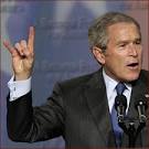 Former US president George W Bush: hook em horns hand gesture photo - president-george-w-bush-hook-em-horns-hand-gesture