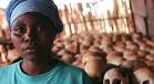 ©Stephen Morrison/EPA/Corbis. A survivor stands before hundreds of skulls at ... - rwanda