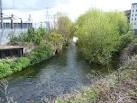 and Plough Lane has allotments on the left bank followed by commerce, - via Daymix