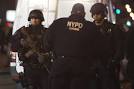 Two N.Y. police officers slain in apparent retribution attack.
