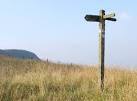 Ageing signpost on Craig Y Llyn. With rotting wood and split pointers, - via Daymix