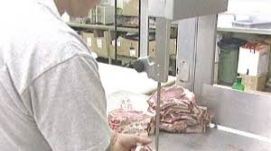 Noel Jervis cuts wild game meat destined for the Calgary Interfaith Food Bank - image