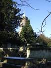 St John's church tower and spire. A light covering of snow on the graves - via Daymix