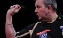 Phil Taylor in action during his opening game in the PDC World Darts ...