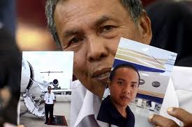 Selamat Omar, showing pictures of his son, flight engineer Mohd Khairul Amri Selamat, who was on board flight MH370. - Bernama - PTJ06_160314_MH370