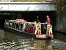 Perseus, a trip boat which plies the Regent's Canal, heads under the Great - via Daymix