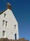 windows and the door facing the sea and the vicious prevailing winds. - via Daymix